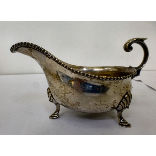 191 - A silver sauce boat with a gadrooned lip, raised on pad feet&nbsp; Sheffield 1944&nbsp; (approx. 247... 
