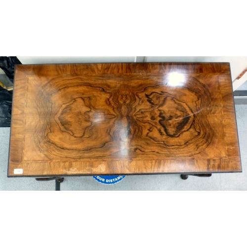 198 - An early 20thC walnut veneered side table with three drawers, raised on cabriole legs and pad feet&n... 