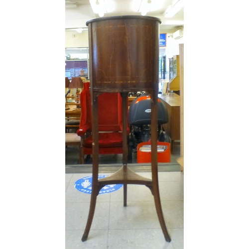 199 - An Edwardian string and ebony inlaid mahogany jardinière stand, raised on three carved legs, united ... 