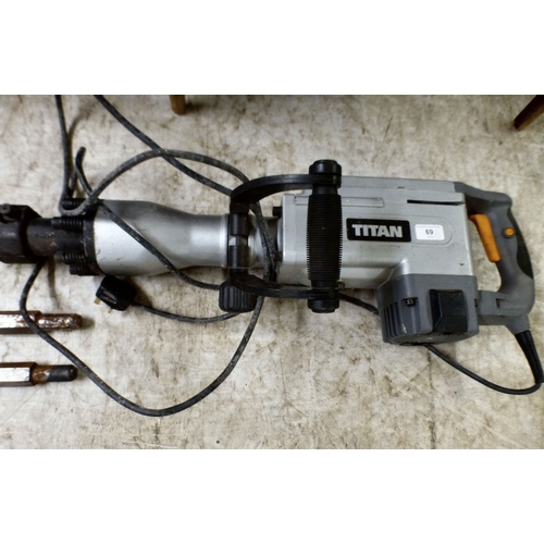 69 - An electrically powered Titan concrete breaker with two spare head attachments