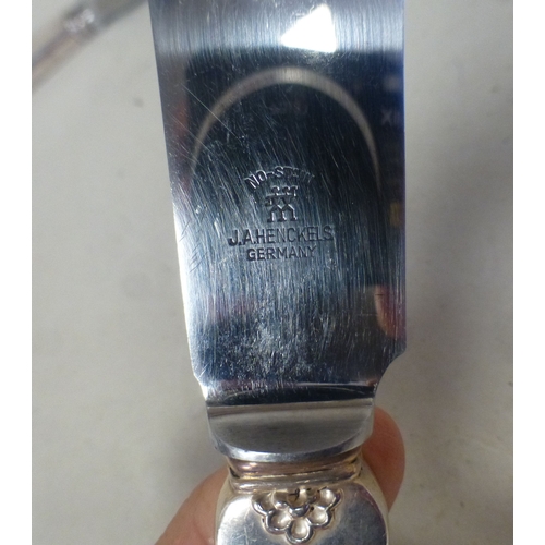 96 - A Georg Jensen Sterling silver handled cake knife with an acorn pattern terminal  boxed  10.5