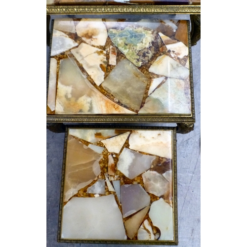 98 - A modern nesting set of three gilt metal framed tables with hardstone and resin surfaces, raised on ... 
