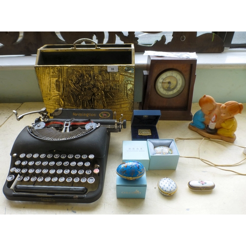 99 - A mixed lot: to include a Remington typewriter; and an embossed brass magazine rack&nbsp; 11