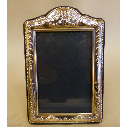 10 - Three silver photograph frames, all on fabric easel backs  mixed marks  various ages & sizes