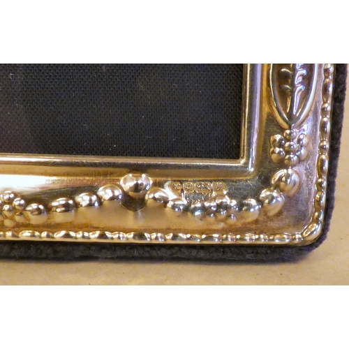 10 - Three silver photograph frames, all on fabric easel backs  mixed marks  various ages & sizes
