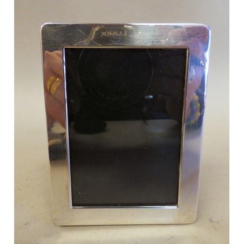 10 - Three silver photograph frames, all on fabric easel backs  mixed marks  various ages & sizes