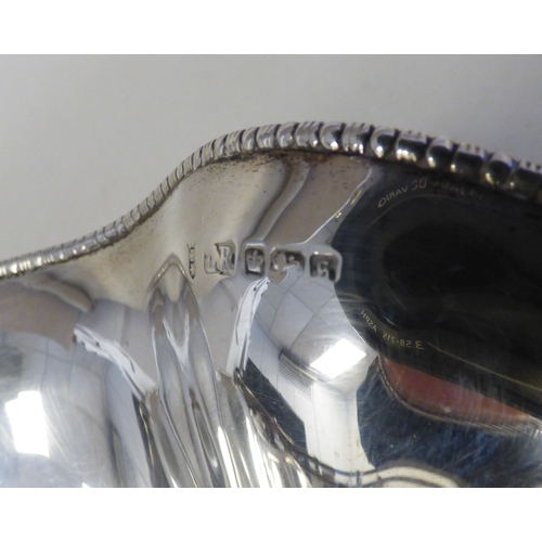13 - A George V silver pedestal sweet basket with a swing handle and wavy edged border&nbsp; Sheffield 19... 
