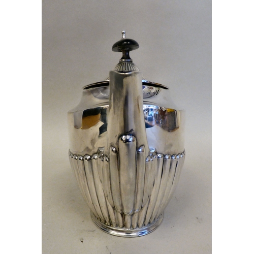15 - An Elizabeth II silver teapot of Victorian influence demi-reeded form and wooden handle&nbsp; Sheffi... 