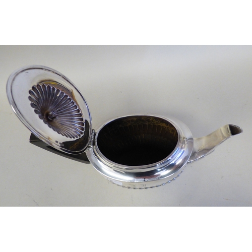 15 - An Elizabeth II silver teapot of Victorian influence demi-reeded form and wooden handle&nbsp; Sheffi... 