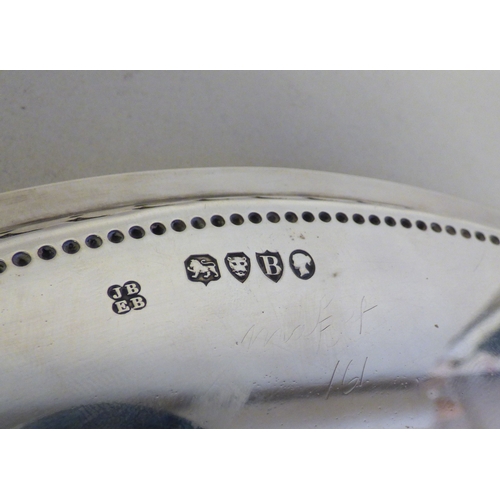 16 - A Victorian silver plate with a pierced border, raised on a trio of cast shell design feet&nbsp; Lon... 