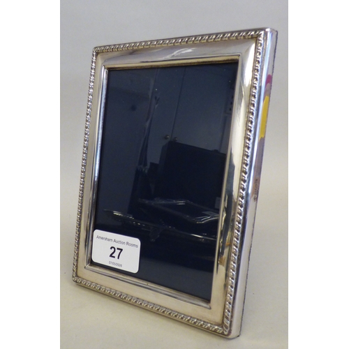 27 - A silver photograph frame with a border, on a fabric easel back  Sheffield 1997  3.5