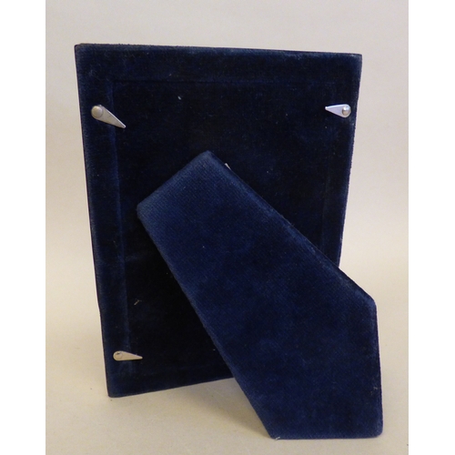 27 - A silver photograph frame with a border, on a fabric easel back  Sheffield 1997  3.5