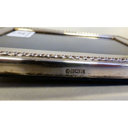 27 - A silver photograph frame with a border, on a fabric easel back  Sheffield 1997  3.5