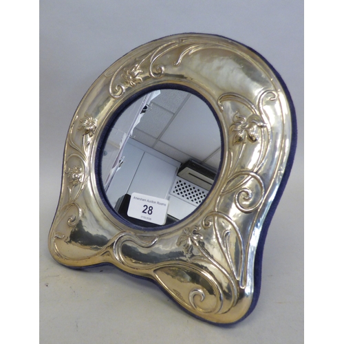 28 - An Art Nouveau influenced white metal photograph frame, the central mirrored cartouche 5
