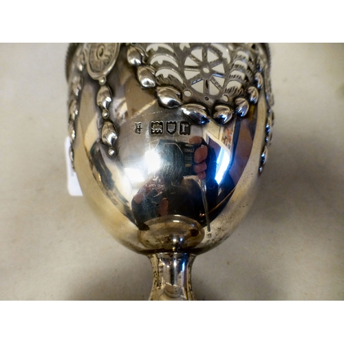 36 - A silver sugar basket of pedestal design with embossed garland ornament and a swing top handle&nbsp;... 