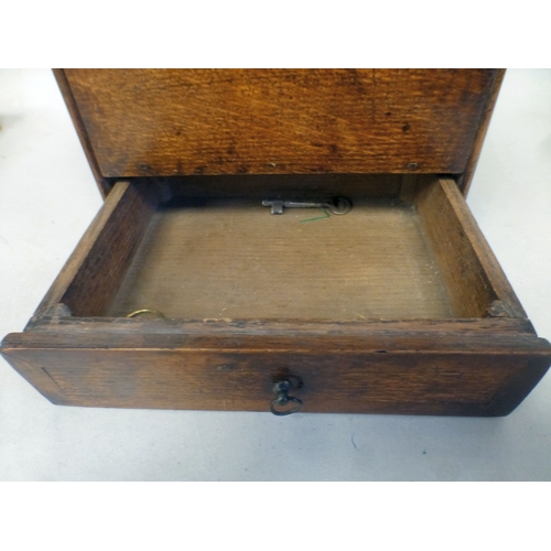 37 - A George III oak candle box with a hinged lid and base drawer&nbsp; 10
