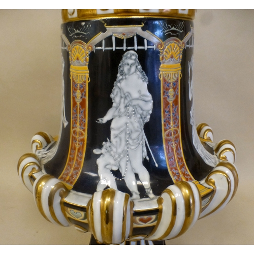 49 - A late 19thC porcelain pate-sur-pate pedestal vase and cover, decorated with panels, featuring class... 