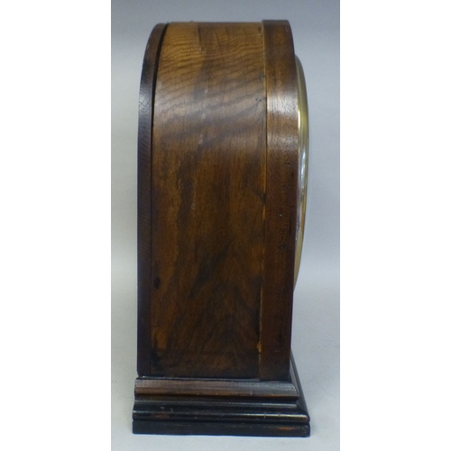 51 - An Edwardian oak cased mantel clock; the movement faced by a Roman dial&nbsp; 16
