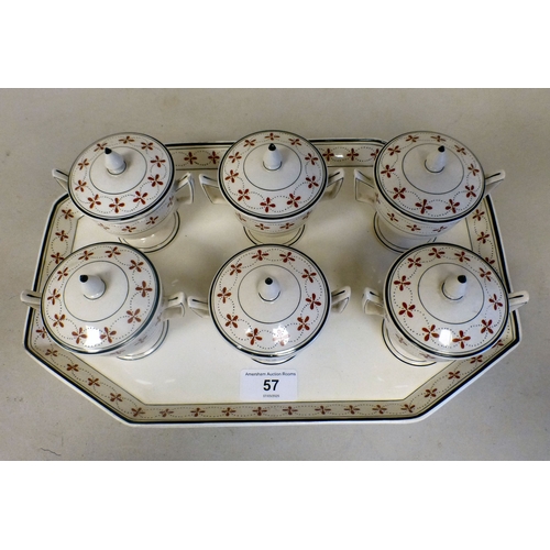 57 - A late 19thC Wedgwood creamware custard set, decorated in the manner of Alfred Powell  comprising si... 