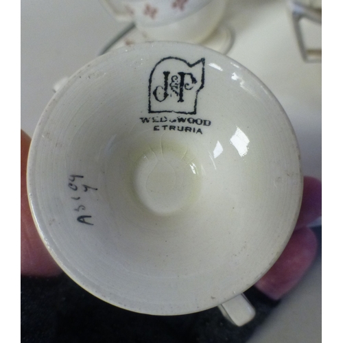 57 - A late 19thC Wedgwood creamware custard set, decorated in the manner of Alfred Powell  comprising si... 