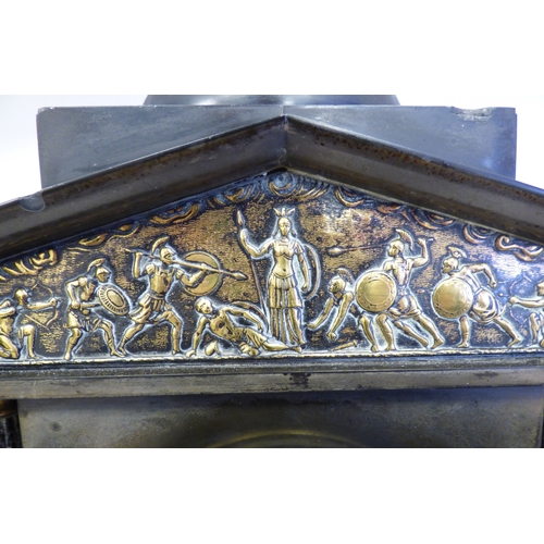 8 - An early 20thC black slate cased mantel clock of architectural form, depicting a Roman battle scene ... 