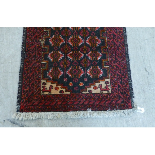 A Persian runner, decorated with geometric motifs, on a red ground 68 ...