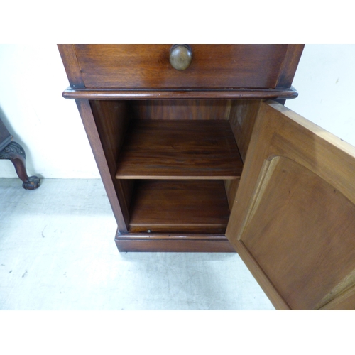 44 - An early 20thC mahogany bureau with a fall flap, over three graduated drawers, raised on carved, stu... 