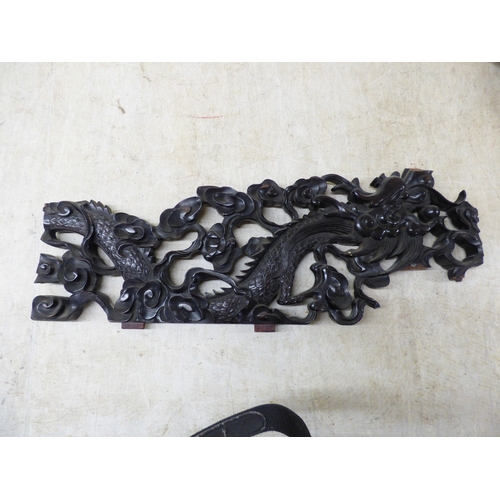 47 - A 20thC carved Chinese fruitwood panel, depicting a dragon and clouds&nbsp; 18
