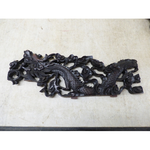 47 - A 20thC carved Chinese fruitwood panel, depicting a dragon and clouds&nbsp; 18