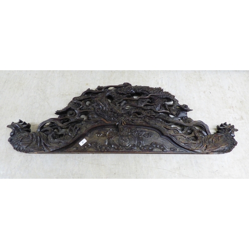 47 - A 20thC carved Chinese fruitwood panel, depicting a dragon and clouds&nbsp; 18
