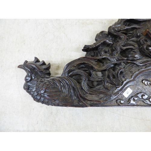 47 - A 20thC carved Chinese fruitwood panel, depicting a dragon and clouds&nbsp; 18