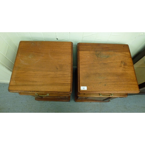 52 - A pair of modern fruitwood bedside chests with a single drawer, over a panelled door, raised on a pl... 