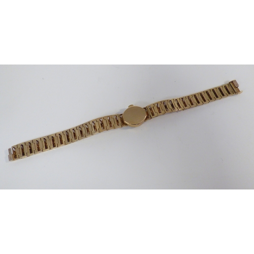16 - A lady's Rotary 9ct gold cased, manual bracelet wristwatch, faced by a baton dial  (approx. 23.1grms... 