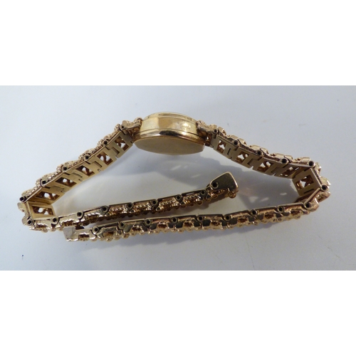 16 - A lady's Rotary 9ct gold cased, manual bracelet wristwatch, faced by a baton dial  (approx. 23.1grms... 