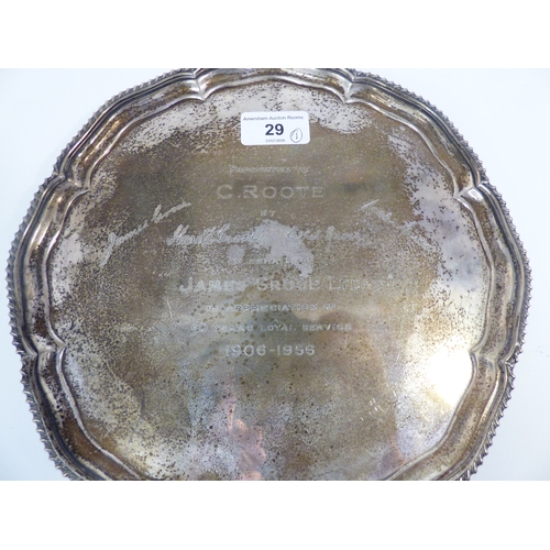 29 - A silver salver with a cast gadrooned edge, raised on talon and ball feet&nbsp; Sheffield 1957&nbsp;... 