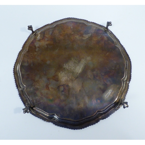 29 - A silver salver with a cast gadrooned edge, raised on talon and ball feet&nbsp; Sheffield 1957&nbsp;... 