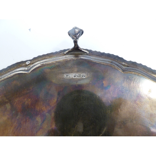 29 - A silver salver with a cast gadrooned edge, raised on talon and ball feet&nbsp; Sheffield 1957&nbsp;... 