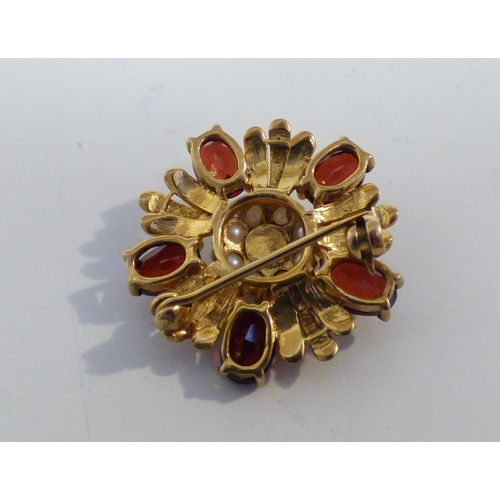 32 - A yellow metal petal design garnet and seed pearl brooch&nbsp; (approx. 5.5grms)