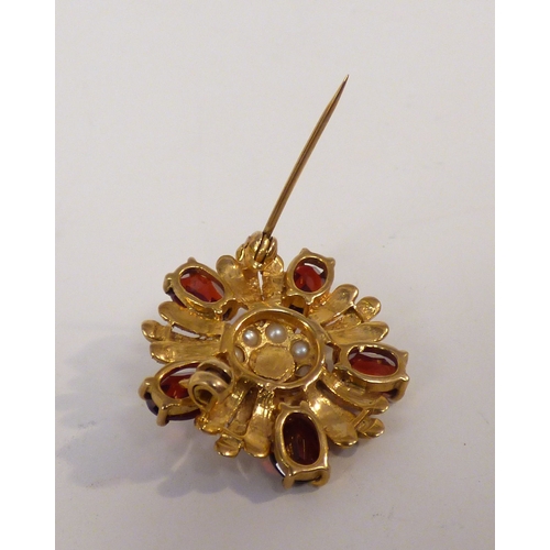 32 - A yellow metal petal design garnet and seed pearl brooch&nbsp; (approx. 5.5grms)