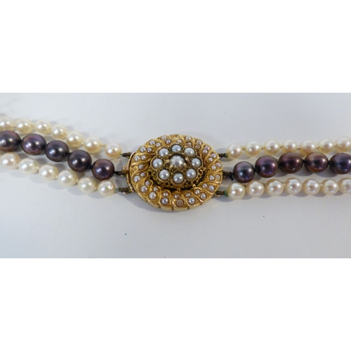 33 - A cultured pearl, triple string necklace, on a 9ct gold clasp