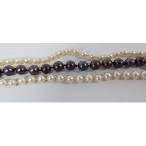 33 - A cultured pearl, triple string necklace, on a 9ct gold clasp