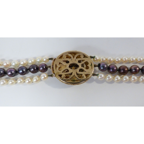 33 - A cultured pearl, triple string necklace, on a 9ct gold clasp