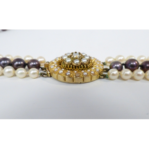 33 - A cultured pearl, triple string necklace, on a 9ct gold clasp