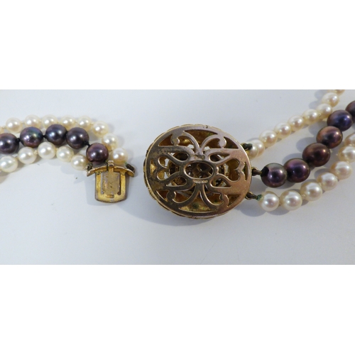 33 - A cultured pearl, triple string necklace, on a 9ct gold clasp