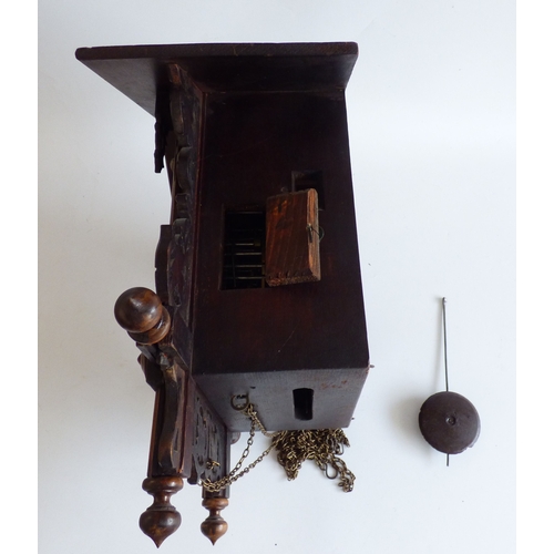 39 - A 20thC stained beech and carved softwood cuckoo clock&nbsp; 15