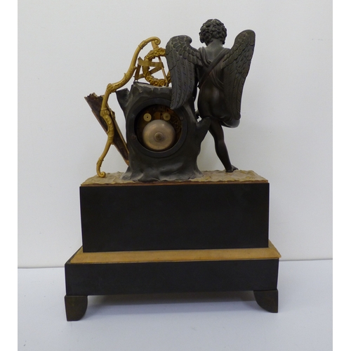 4 - An early 20thC (probably) French bronze and gilt metal cased mantel clock, surmounted by an angelic ... 
