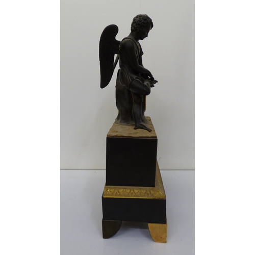 4 - An early 20thC (probably) French bronze and gilt metal cased mantel clock, surmounted by an angelic ... 