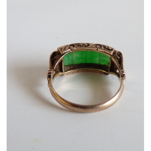 48 - A Chinese style yellow metal ring, set with four jade coloured stone tablets  stamped 14k  (approx. ... 