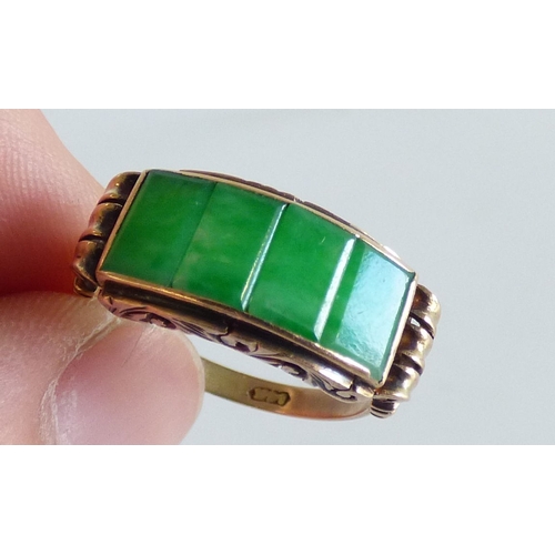 48 - A Chinese style yellow metal ring, set with four jade coloured stone tablets  stamped 14k  (approx. ... 