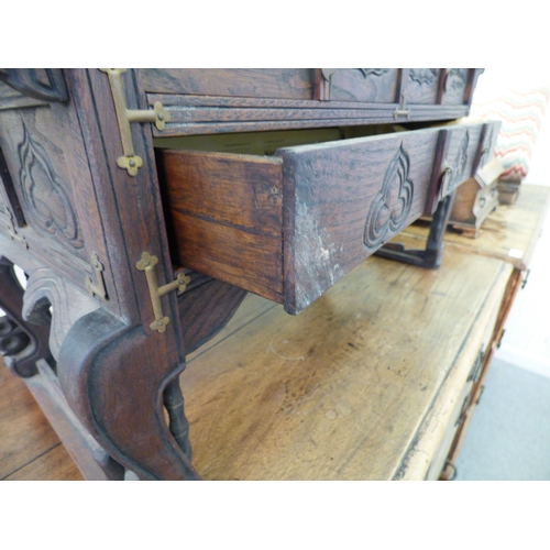 58 - A 20thC Korean style fruitwood table top, altar style, three drawer cabinet, raised on carved feet  ... 
